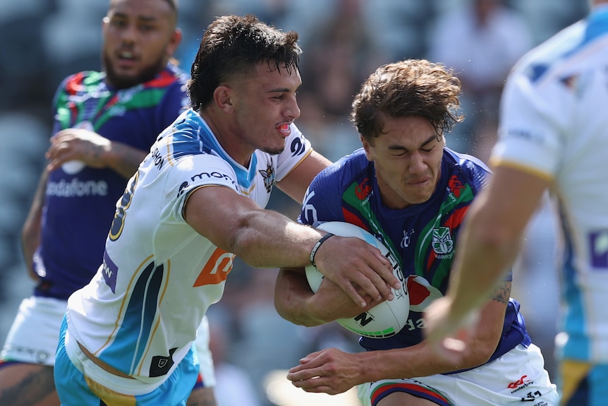 Rugby league player tackling another with the ball during a match