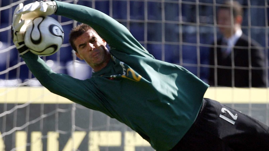 Ante Covic dives to catch a ball during a training session in Rotterdam ahead of Australia's 2006 World Cup finals campaign
