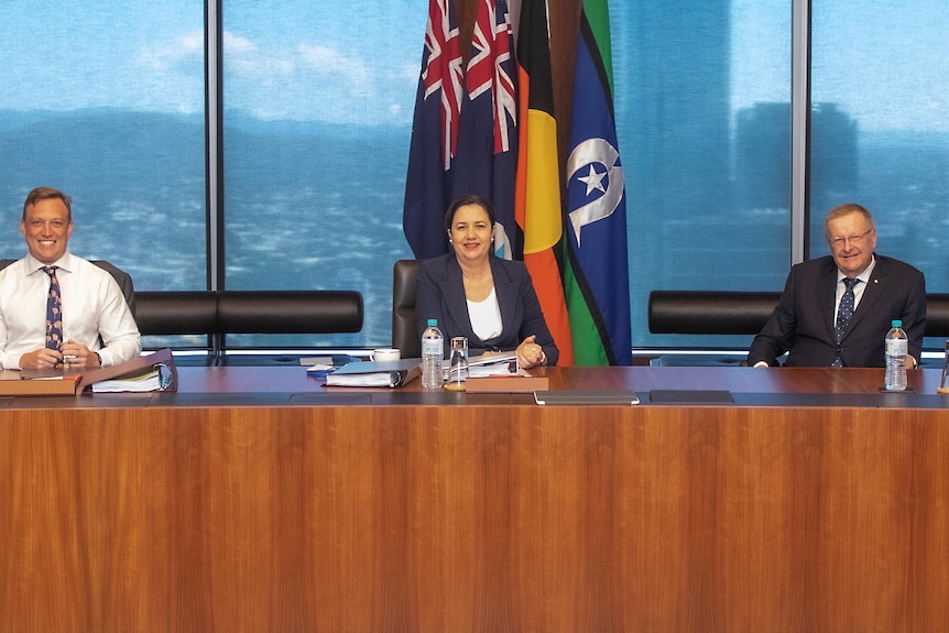 The Premier with her deputy and John Coates sitting at a table during a cabinet meeting.