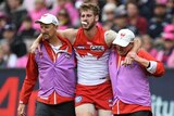 Alex Johnson is helped off the field
