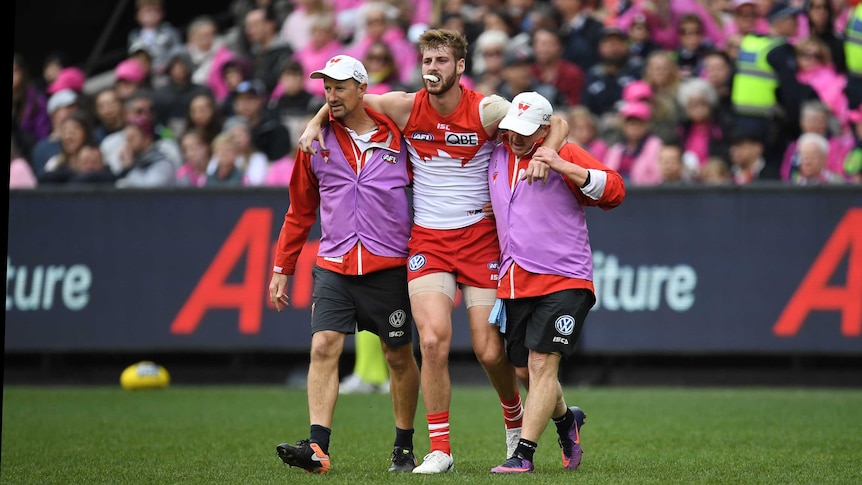 Alex Johnson is helped off the field