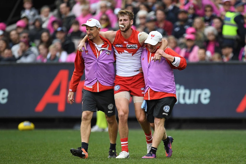 Alex Johnson is helped off the field