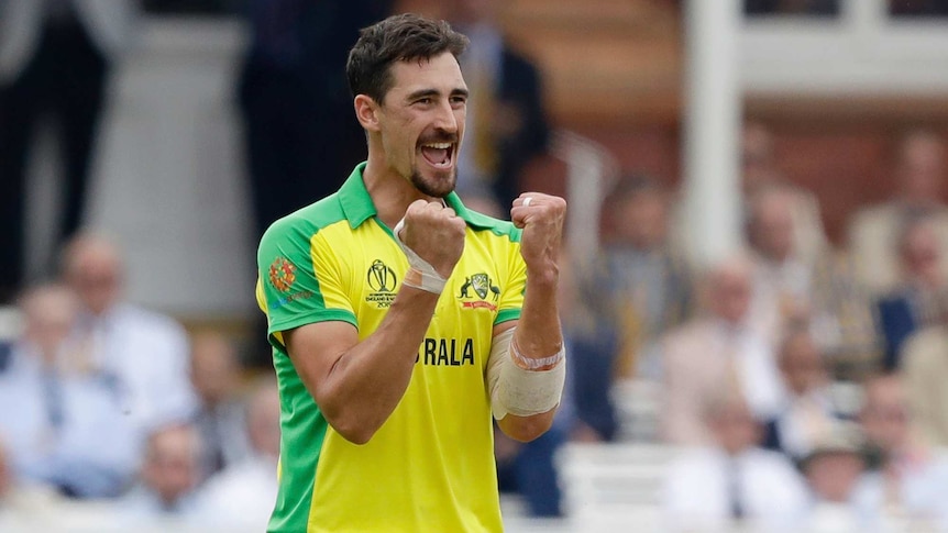 Mitchell Starc clenches both his fists and opens his mouth in a wide smile