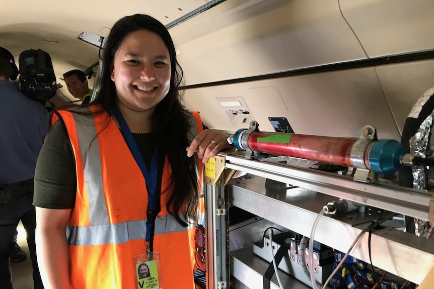 Christina McCluskey from National Centre of Atmospheric Research monitors a cloud-inspired machine on board the aircraft.