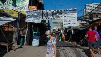 People in a lower income part of Manila with signs saying 'no entry'.