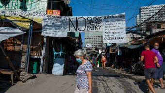 People in a lower income part of Manila with signs saying 'no entry'.