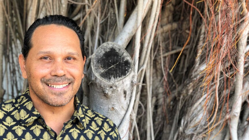 Ben Tyler, founder of Kakadu Kitchen, standing in front of a banyan tree in Darwin.