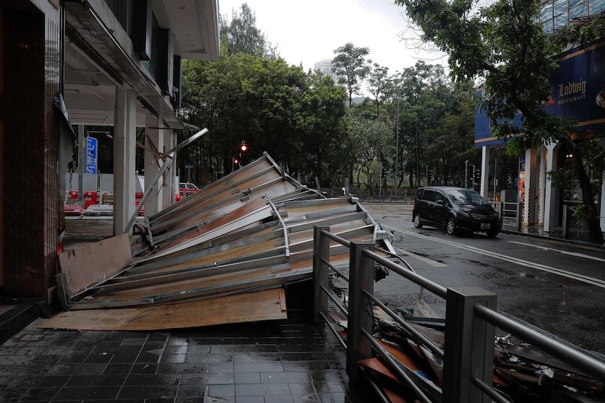 A collapsed wooden wall caused by by Typhoon Hato lies in a street in Hong Kong.