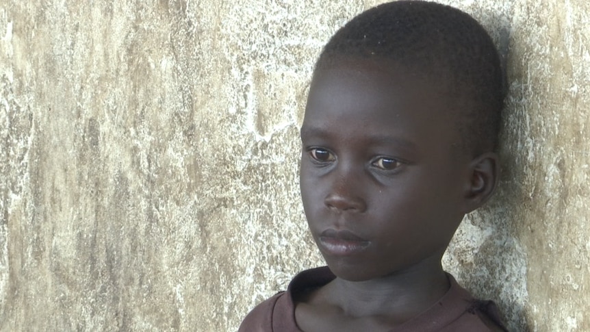South Sudanese refugee boy stares into the distance