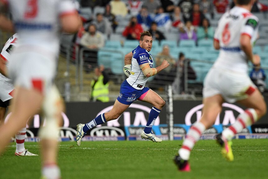 Josh Reynolds of the Bulldogs makes a break to score a try against St George in July 2016.