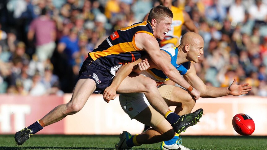 Tight contest ... Gary Ablett (R) is tackled by Scott Selwood