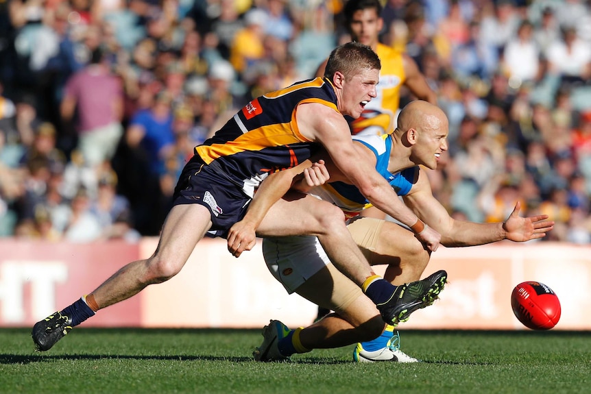 Tight contest ... Gary Ablett (R) is tackled by Scott Selwood