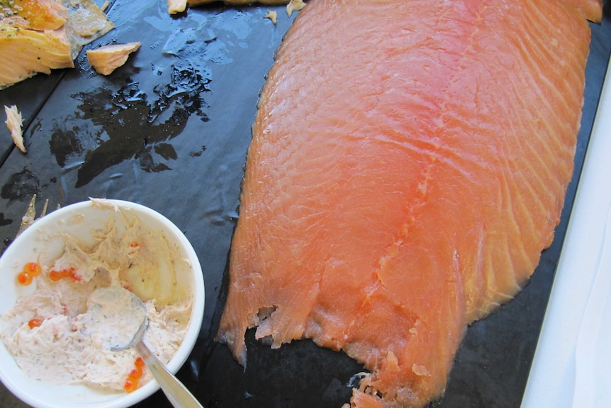 A big slab of smoked salmon and bowl of salmon mousse with salmon caviar