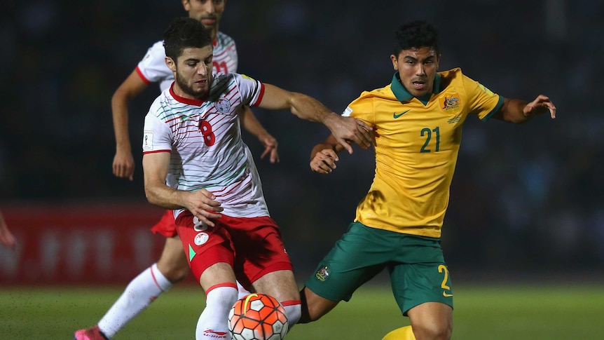 Massimo Luongo is robbed of possession by Nuridden Davronov