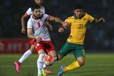 Massimo Luongo is robbed of possession by Nuridden Davronov