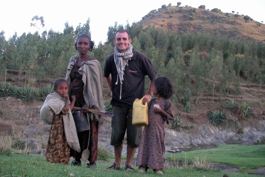 Jeremy with a mother and her two young daughters in Ethiopia.
