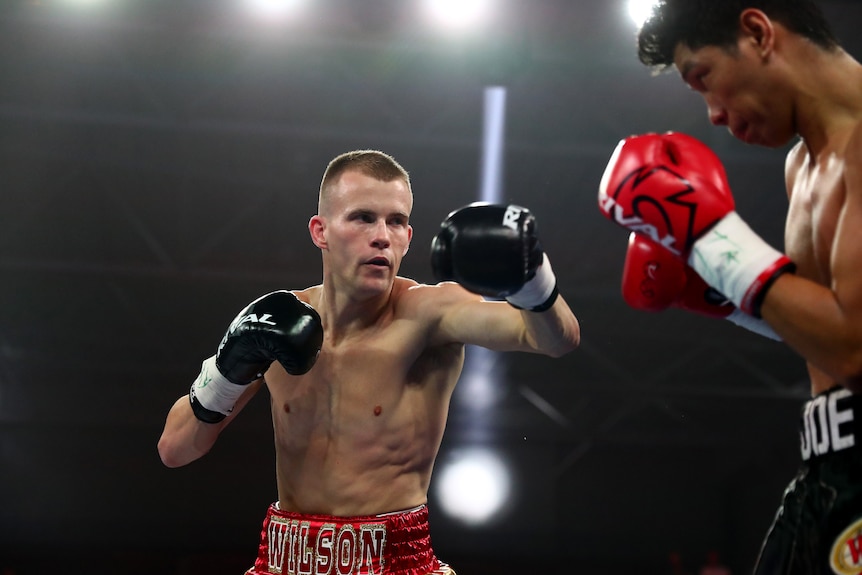 Liam Wilson holds up his gloves in front of Joe Noynay