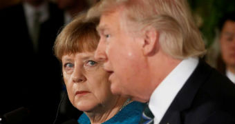 German Chancellor Angela Merkel looks at Donald Trump as he speaks.