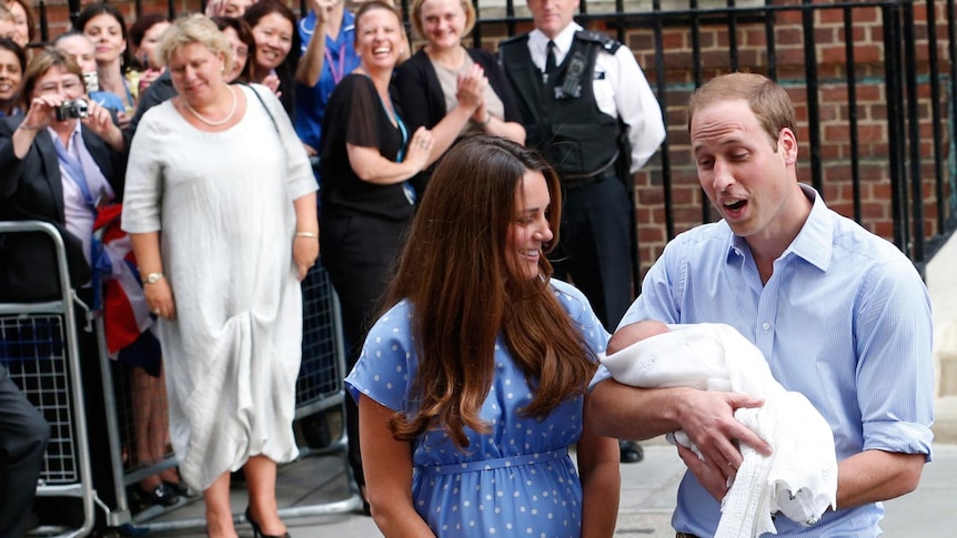 Prince William holds his son outside hospital