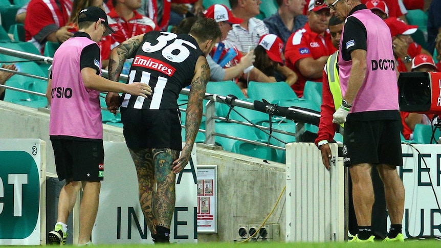 Collingwood's Dane Swan leaves the field injured during a match against Sydney Swans at the SCG.