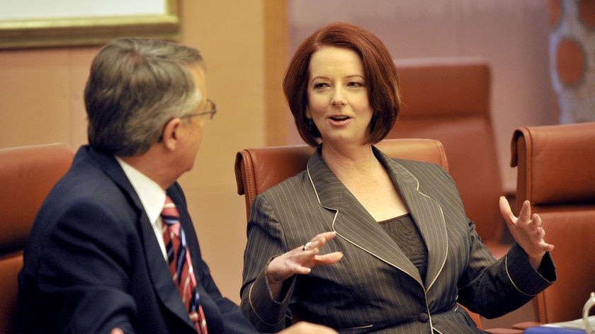Prime Minister Julia Gillard speaks to deputy Wayne Swan during a cabinet meeting in Canberra. (AAP: Alan Porritt)