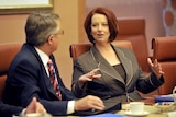 Prime Minister Julia Gillard speaks to her deputy Wayne Swan.