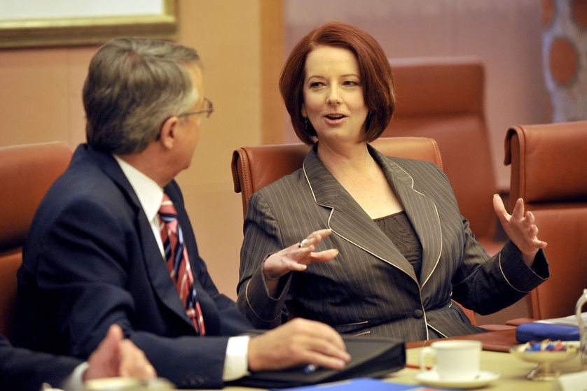 Prime Minister Julia Gillard speaks to deputy Wayne Swan during a cabinet meeting in Canberra. (AAP: Alan Porritt)