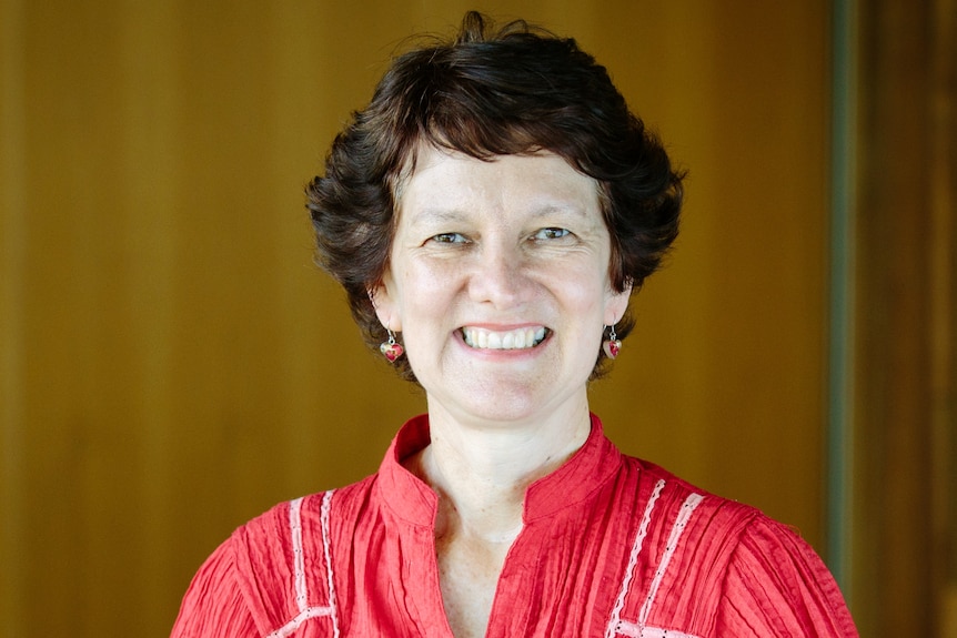 A headshot of a woman with short brown hair. 