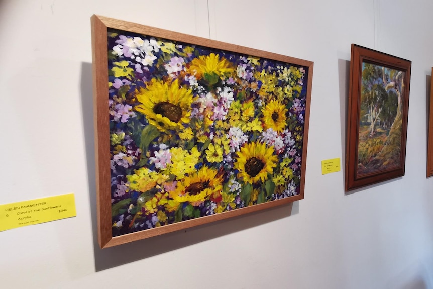 A painting of flowers including sunflowers.