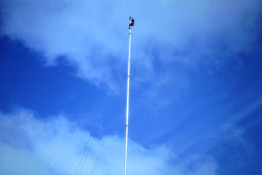 Brian Rieusset up an antenna at Casey Station, 1968