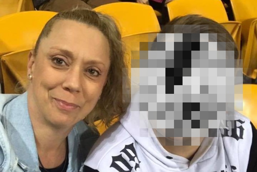 a woman takes a selfie with a boy whose face is pixelated and can't be identified