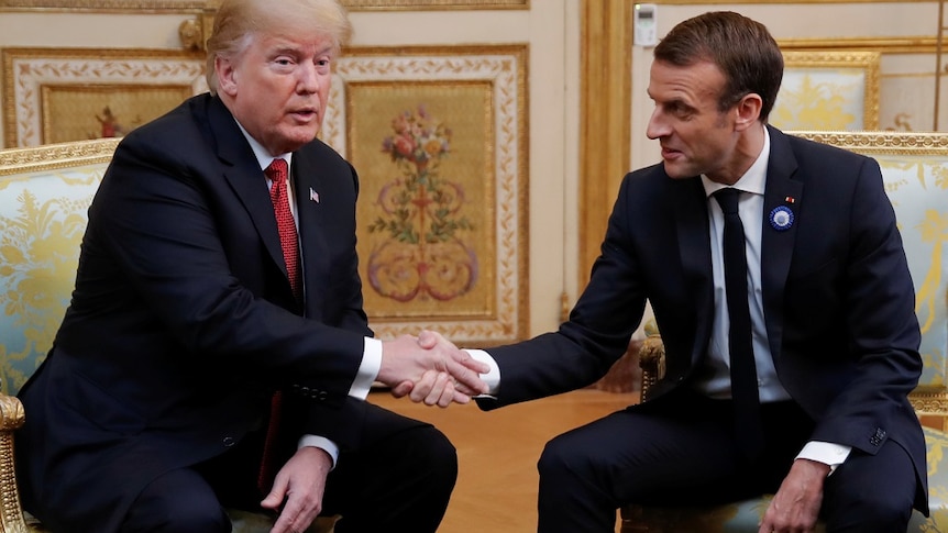US President Donald Trump (left) shakes hands with French President Emmanuel Macron