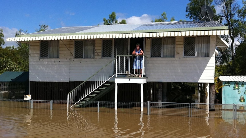 Betty Phillis watches the floodwaters from her Depot Hill home