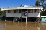 Betty Phillis watches the floodwaters from her Depot Hill home