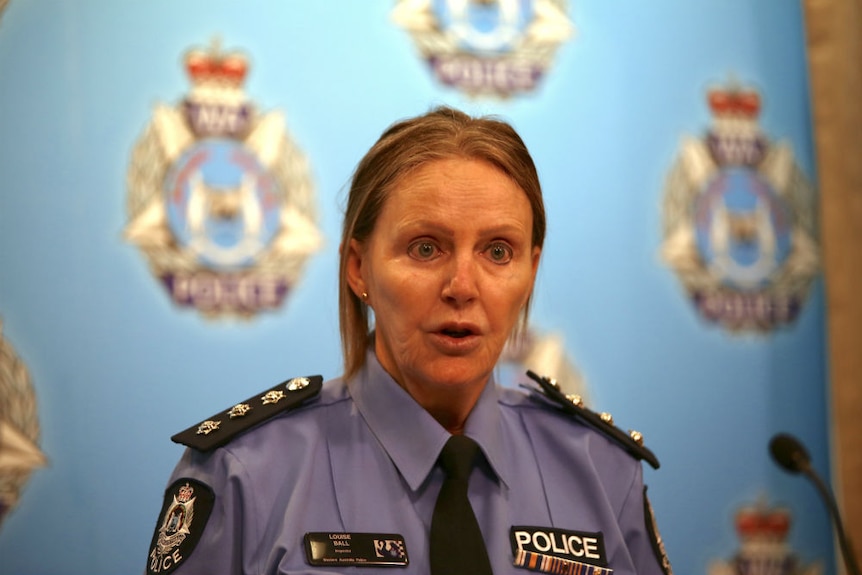 Inspector Louise Ball standing in front of a blue WA Police backdrop