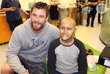 Actor Chris Hemsworth with a young patient