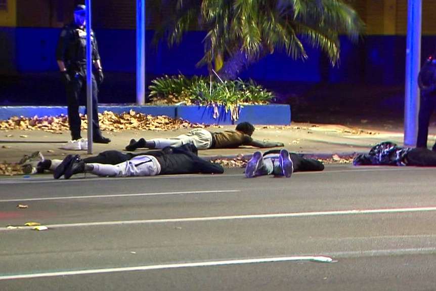 A number of people lay on the streets surrounded by police