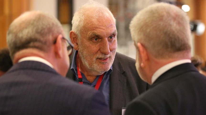 Australian film director Phillip Noyce (centre) speaking with Arts Minister Mitch Fifield (right).