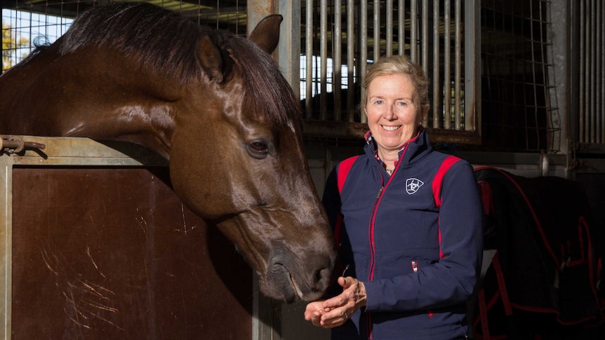 Rozzie Ryan pats a horse.