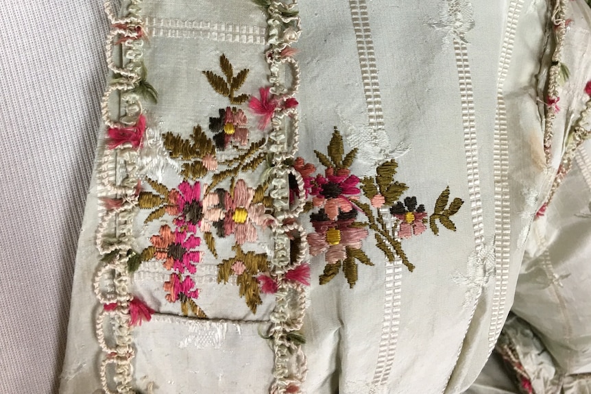 flowers stitched on a silk gown