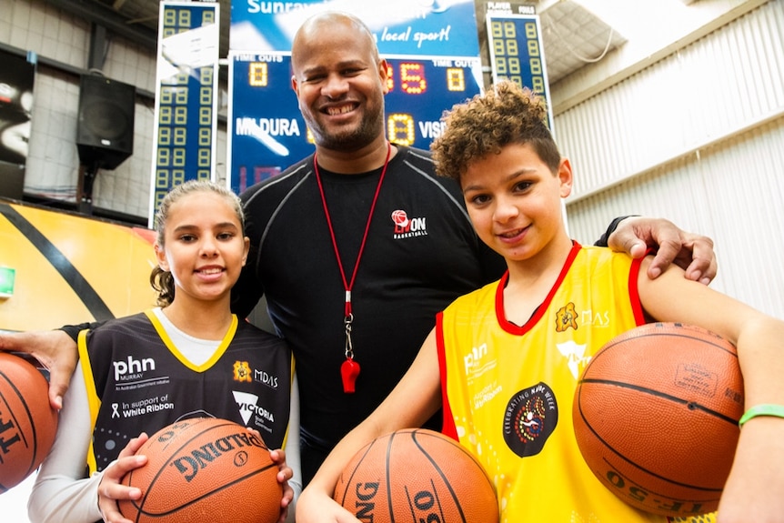 Randy Livingston with two Indigenous youth.