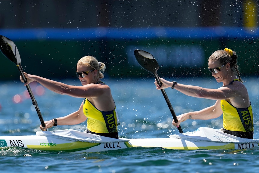 An Australian women's kayak doubles pair paddle in unison during an Olympic semi-final.