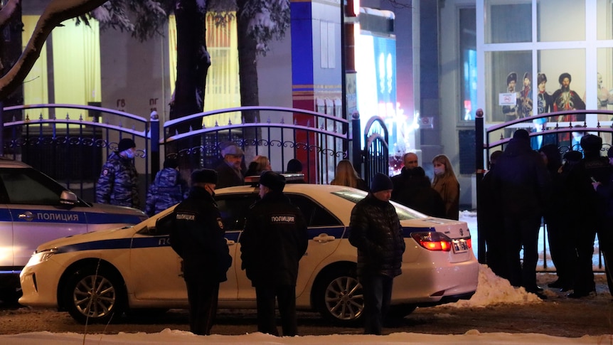 Police guard an area outside the Moscow government services centre in Moscow at night