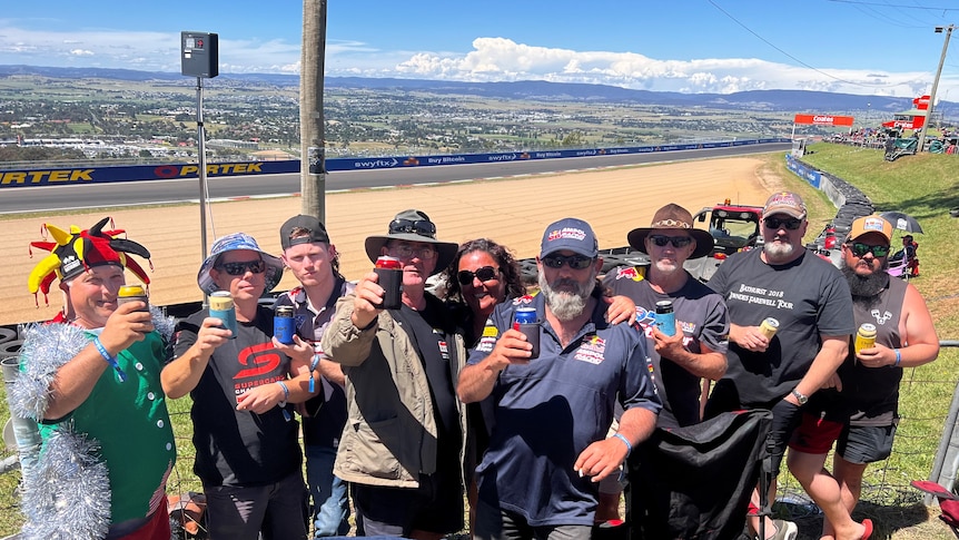 A group of men and women standing alongside the track at the Bathurst 1000