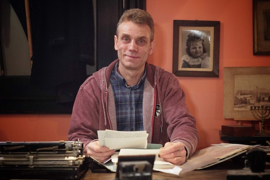 Miroslaw Ganobis sitting at his desk.