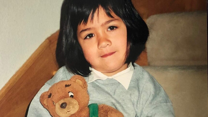 Anna with her teddy at age 4.