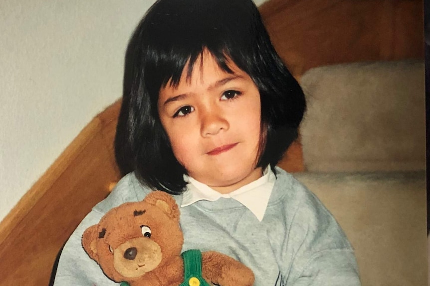 Anna with her teddy at age 4.