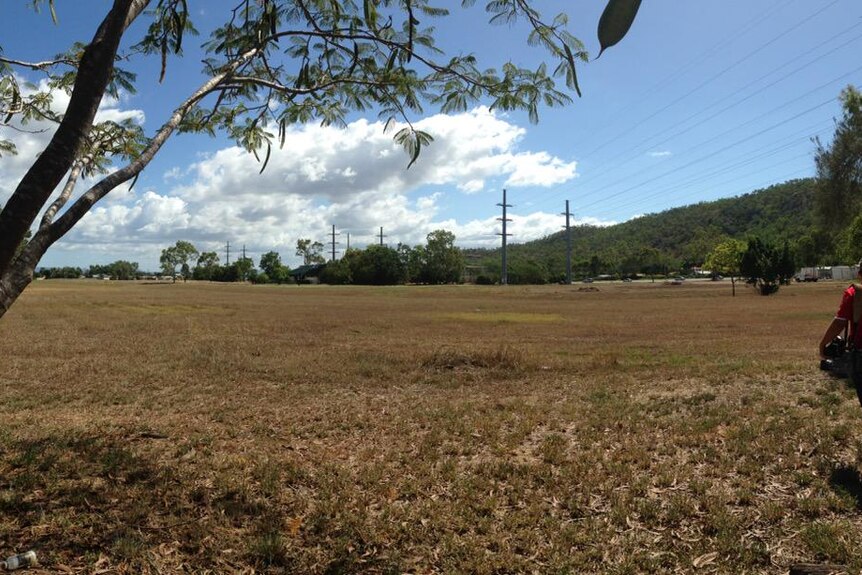 Police are searching this vacant land in Townsville for property belonging to missing woman Julie Hutchinson