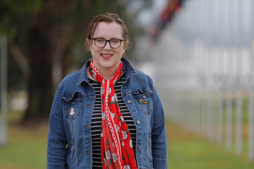 Ashleigh Keating wears a red scarf and denim jacket