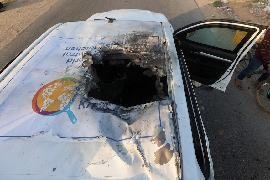 The top of a vehicle, with a large blast hole in it, seen from above